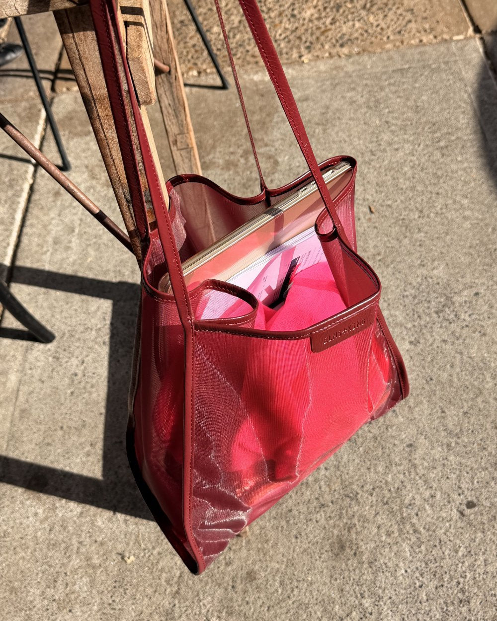 Elms+King Zanzibar Bag Wine Colour hanging on chair