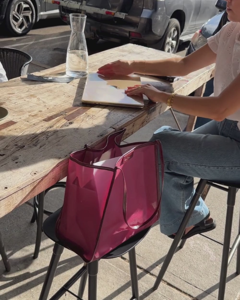 Zanzibar Bag in Wine on chair at cafe